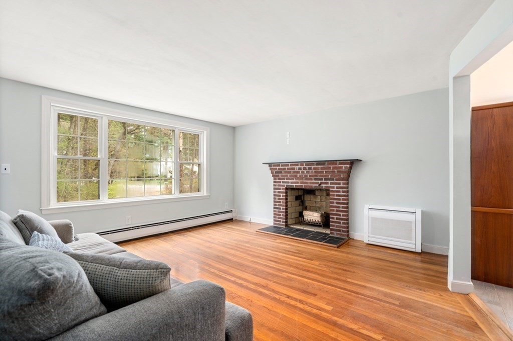 47 Stonebrook Road Sudbury, MA 01776 - Photo 3 of 17 a living room with furniture and a fireplace