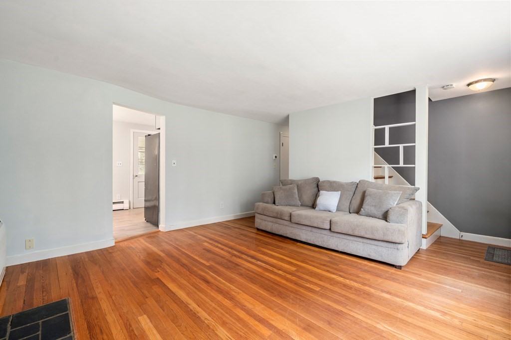47 Stonebrook Road Sudbury, MA 01776 - Photo 4 of 17 a spacious bedroom with a bed and a couch