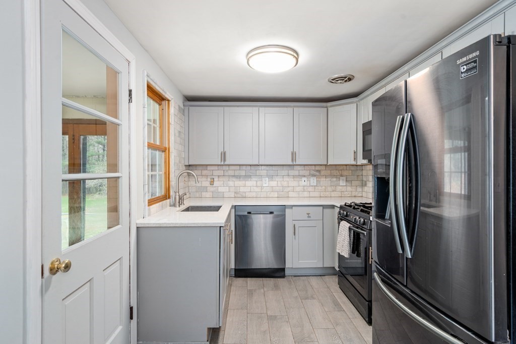 47 Stonebrook Road Sudbury, MA 01776 - Photo 5 of 17 a kitchen with a refrigerator sink and stove