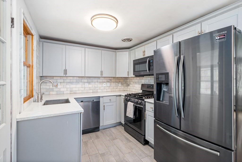 47 Stonebrook Road Sudbury, MA 01776 - Photo 6 of 17 a kitchen with a refrigerator sink and stainless steel appliances