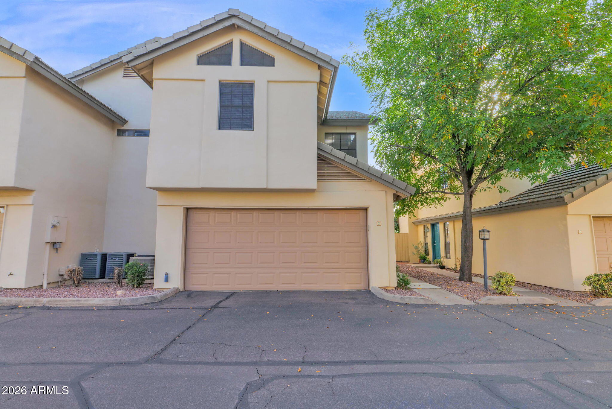 1124 East Rose Lane, Unit 3 Phoenix, AZ 85014 - Photo 1 of 37 a front view of a house with a yard and garage