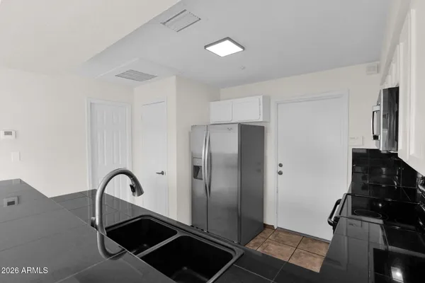 a kitchen with a refrigerator and a stove