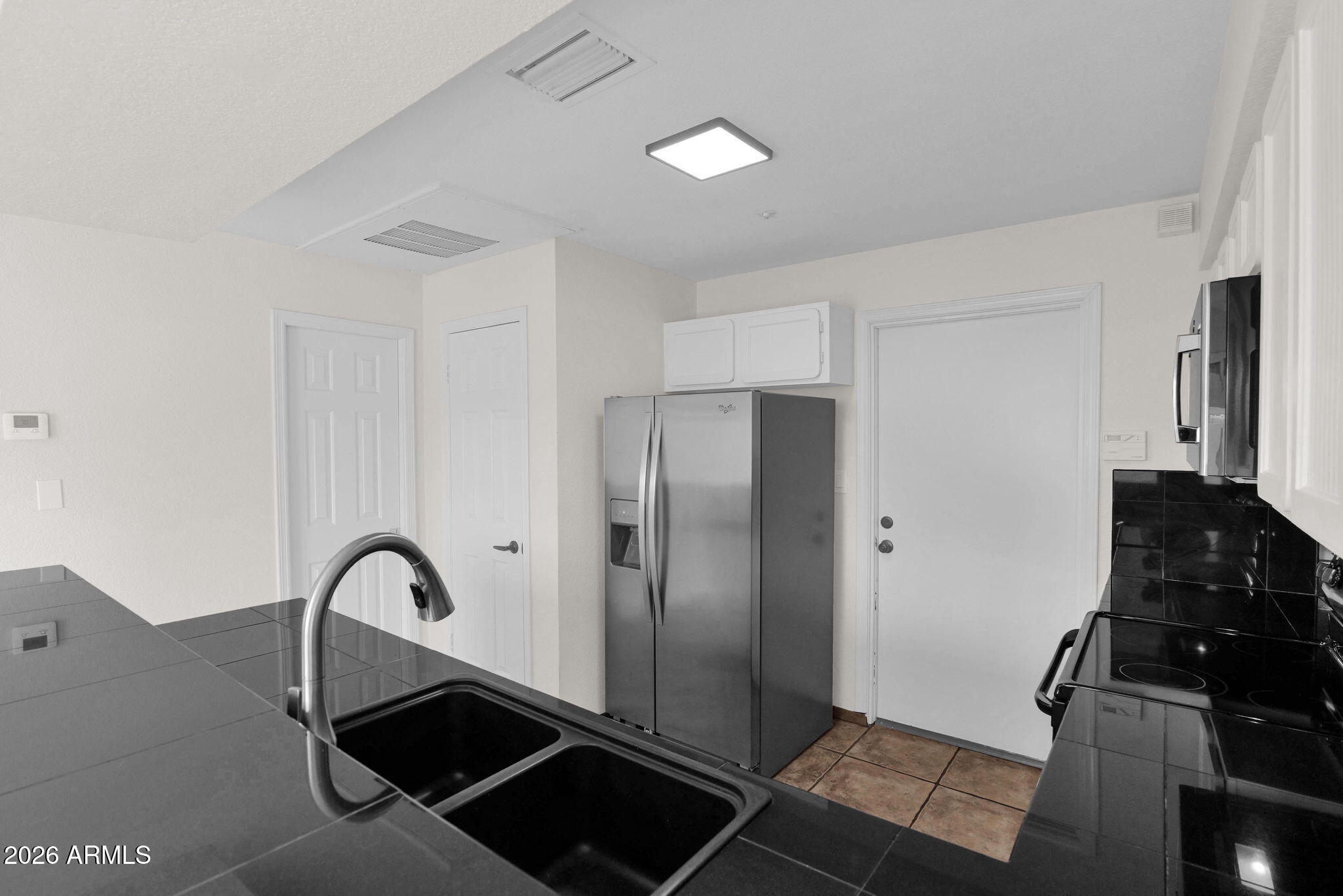 1124 East Rose Lane, Unit 3 Phoenix, AZ 85014 - Photo 12 of 37 a kitchen with a refrigerator and a stove