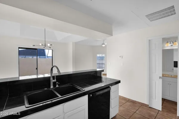 a close view of a sink a counter space and utility room