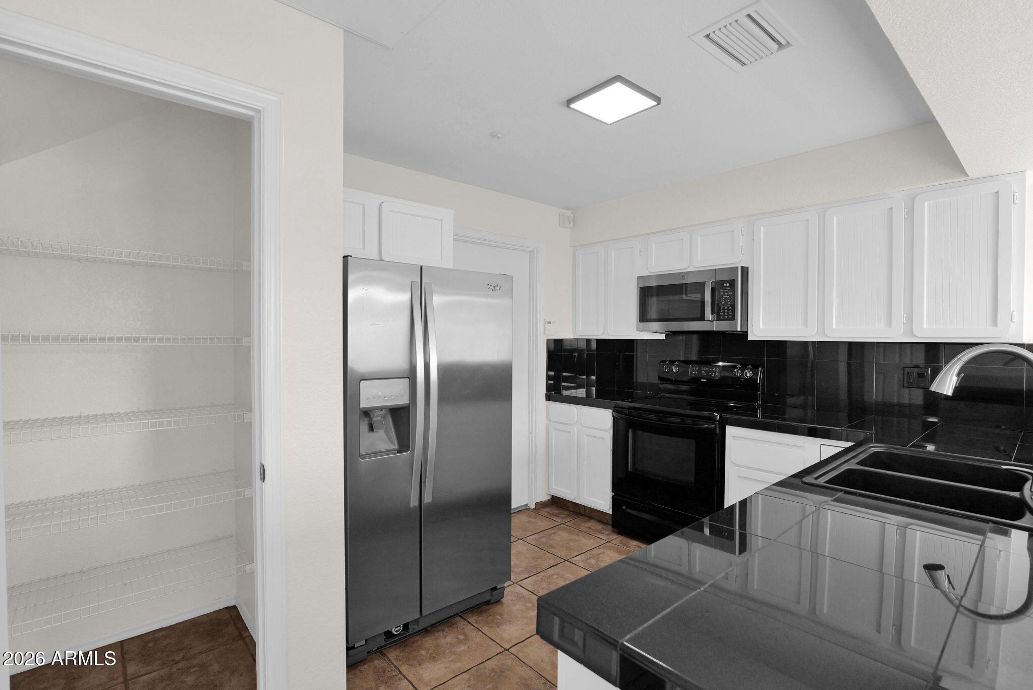 1124 East Rose Lane, Unit 3 Phoenix, AZ 85014 - Photo 15 of 37 a kitchen with a refrigerator stove and microwave