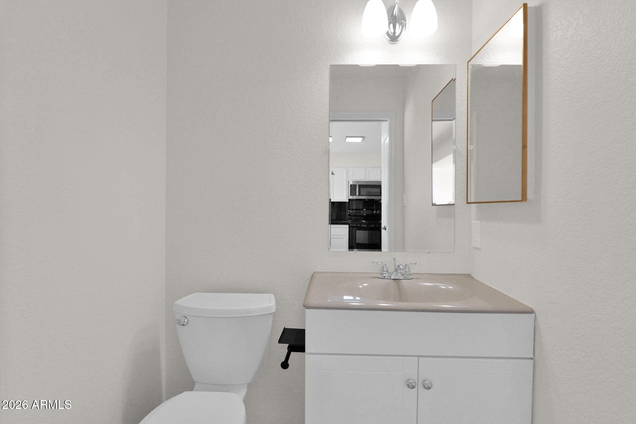 1124 East Rose Lane, Unit 3 Phoenix, AZ 85014 - Photo 16 of 37 a bathroom with a toilet sink and mirror