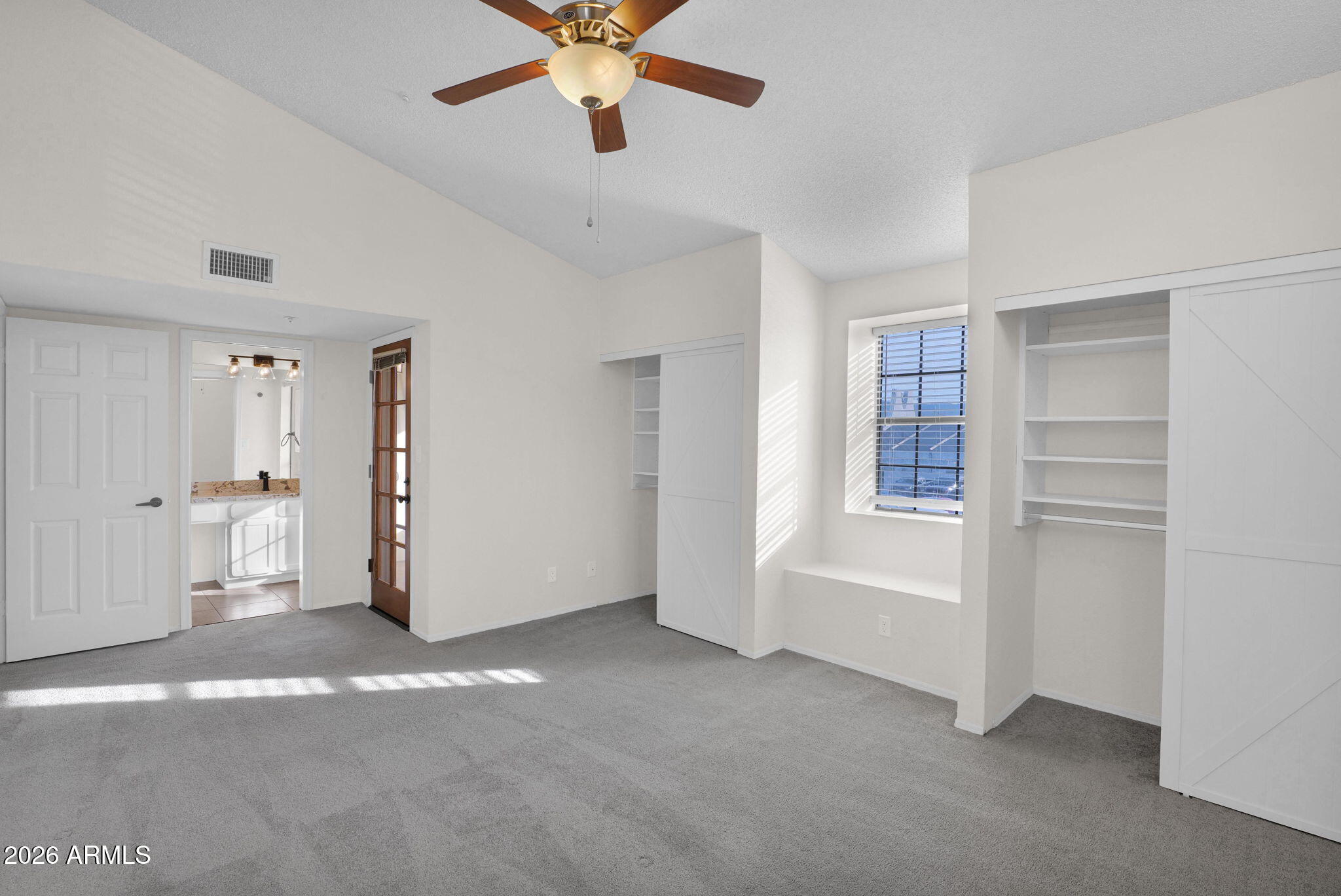 1124 East Rose Lane, Unit 3 Phoenix, AZ 85014 - Photo 19 of 37 a view of a livingroom with a ceiling fan and window