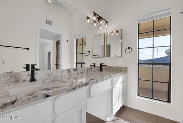 a bathroom with a granite countertop sink mirror and shower