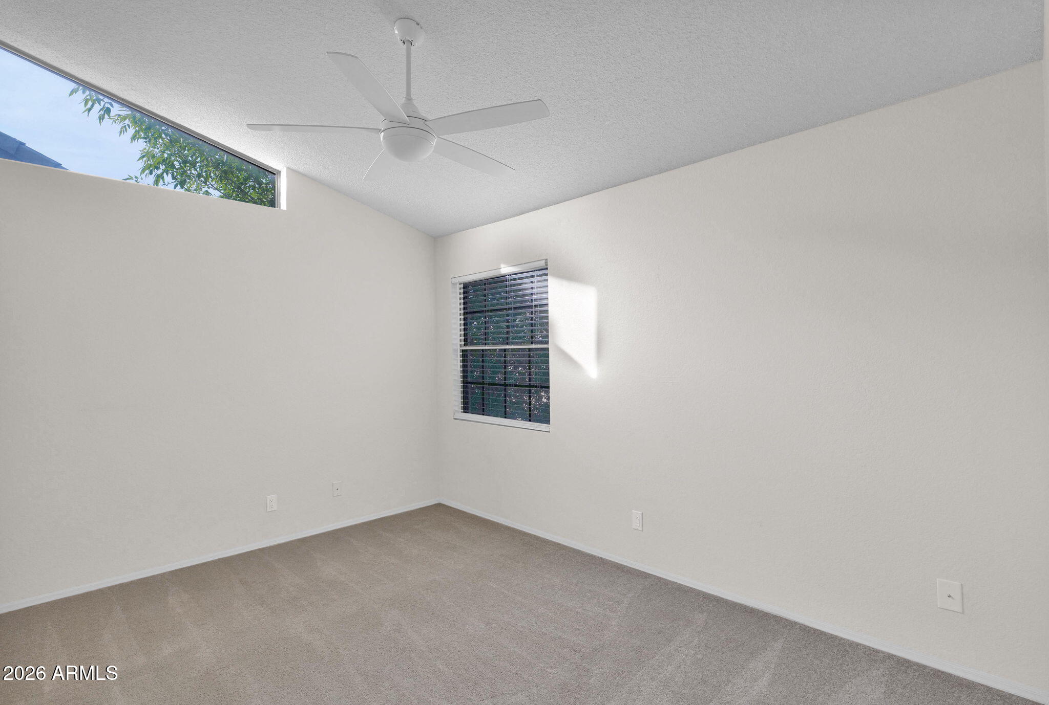 1124 East Rose Lane, Unit 3 Phoenix, AZ 85014 - Photo 27 of 37 an empty room with a ceiling fan and window