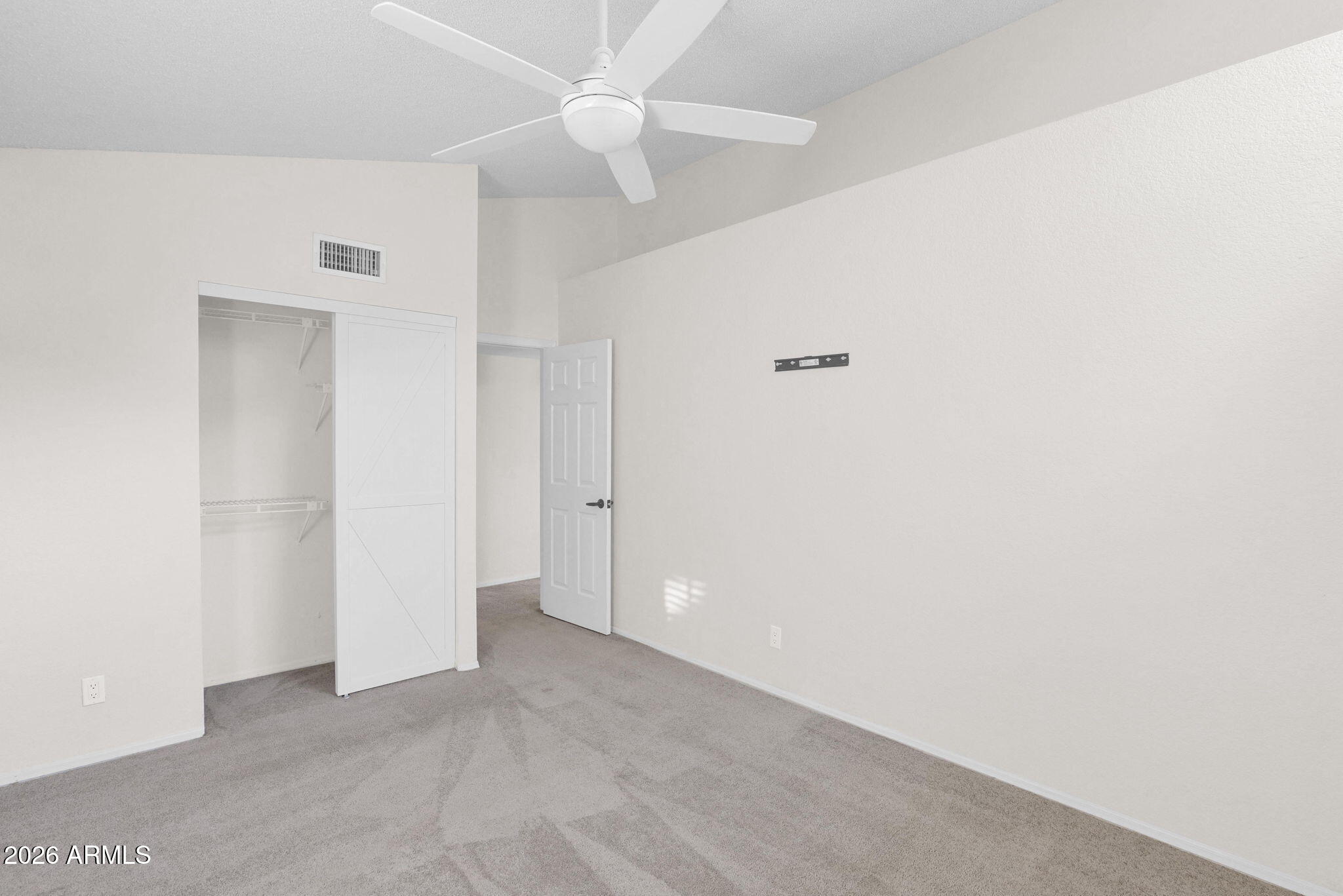 1124 East Rose Lane, Unit 3 Phoenix, AZ 85014 - Photo 28 of 37 an empty room with a ceiling fan and a window