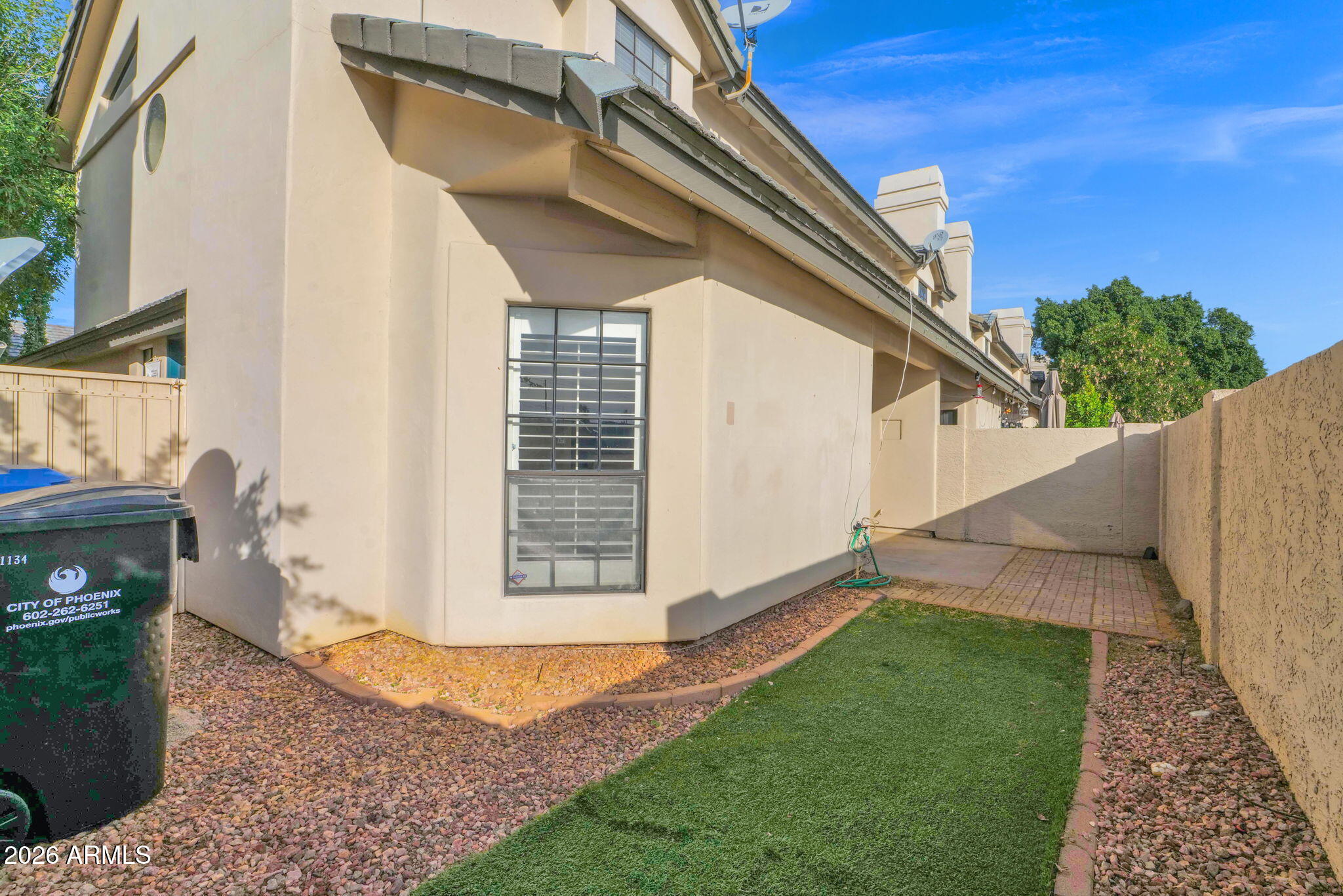 1124 East Rose Lane, Unit 3 Phoenix, AZ 85014 - Photo 30 of 37 a view of a house with a backyard