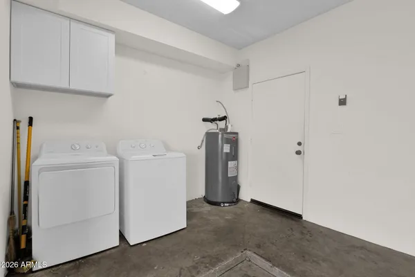 a view of storage and utility room with washer and dryer