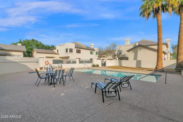 a view of a patio with a table and chairs