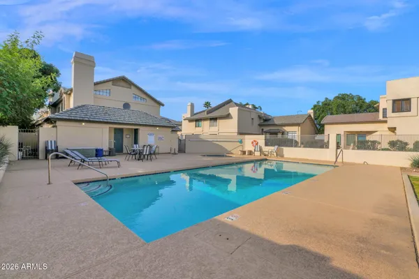 a view of a patio with swimming pool table and chairs