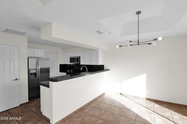 a kitchen view with stainless steel appliances a refrigerator and a stove top oven