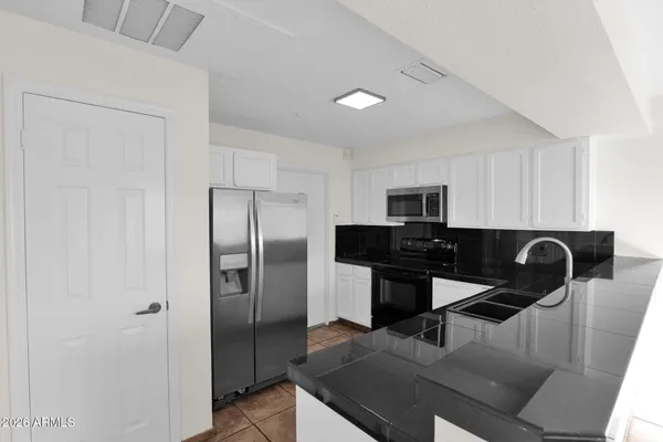 a kitchen with a refrigerator and a sink