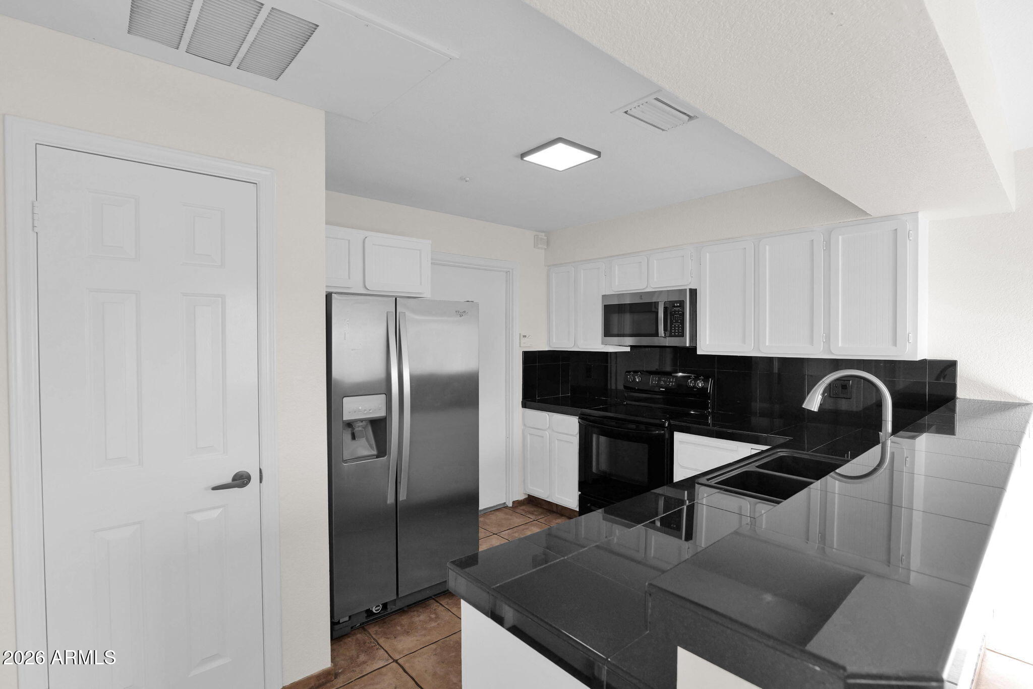 1124 East Rose Lane, Unit 3 Phoenix, AZ 85014 - Photo 10 of 37 a kitchen with a refrigerator and a sink