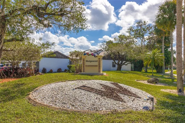 a front view of a house with a yard and trees