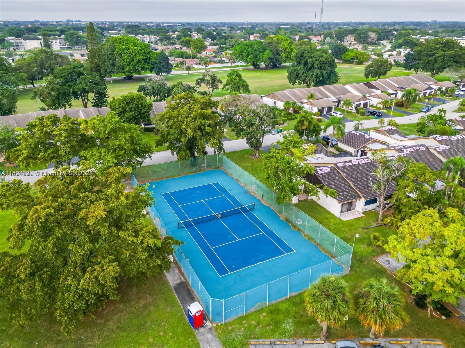 6343 Pinehurst Circle, Unit D36 Tamarac, FL 33321 - Photo 13 of 13 a view of a yard with an umbrella