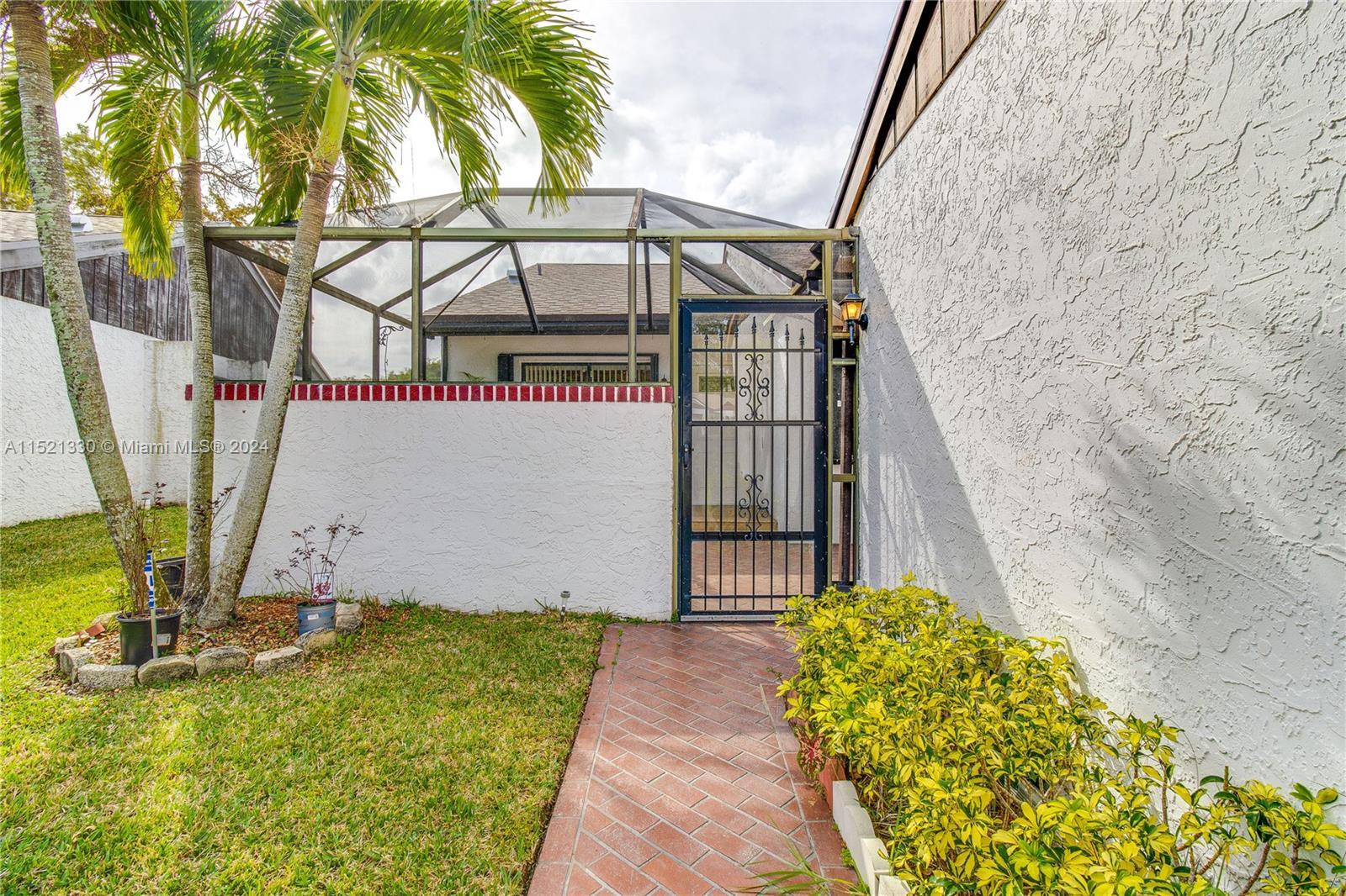 6343 Pinehurst Circle, Unit D36 Tamarac, FL 33321 - Photo 2 of 13 a view of a backyard with a fountain