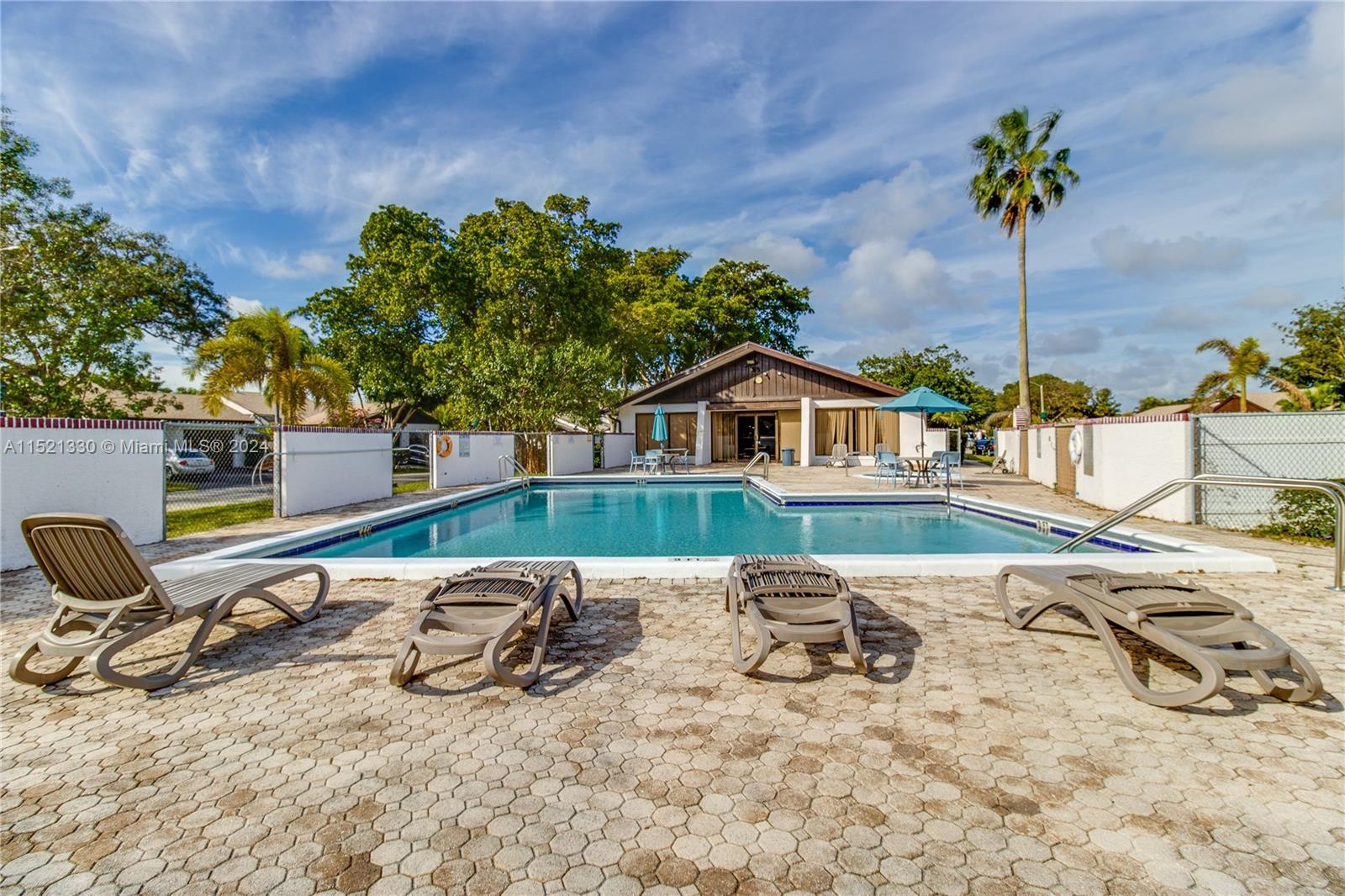 6343 Pinehurst Circle, Unit D36 Tamarac, FL 33321 - Photo 10 of 13 a view of a lounge chair and table in the house