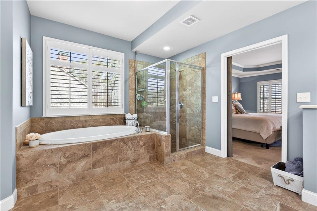 340 Scott Farm Drive Powder Springs, GA 30127 - Photo 29 of 59 a spacious bathroom with a tub and a large window