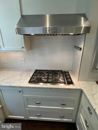 a bathroom with a granite countertop toilet sink and mirror