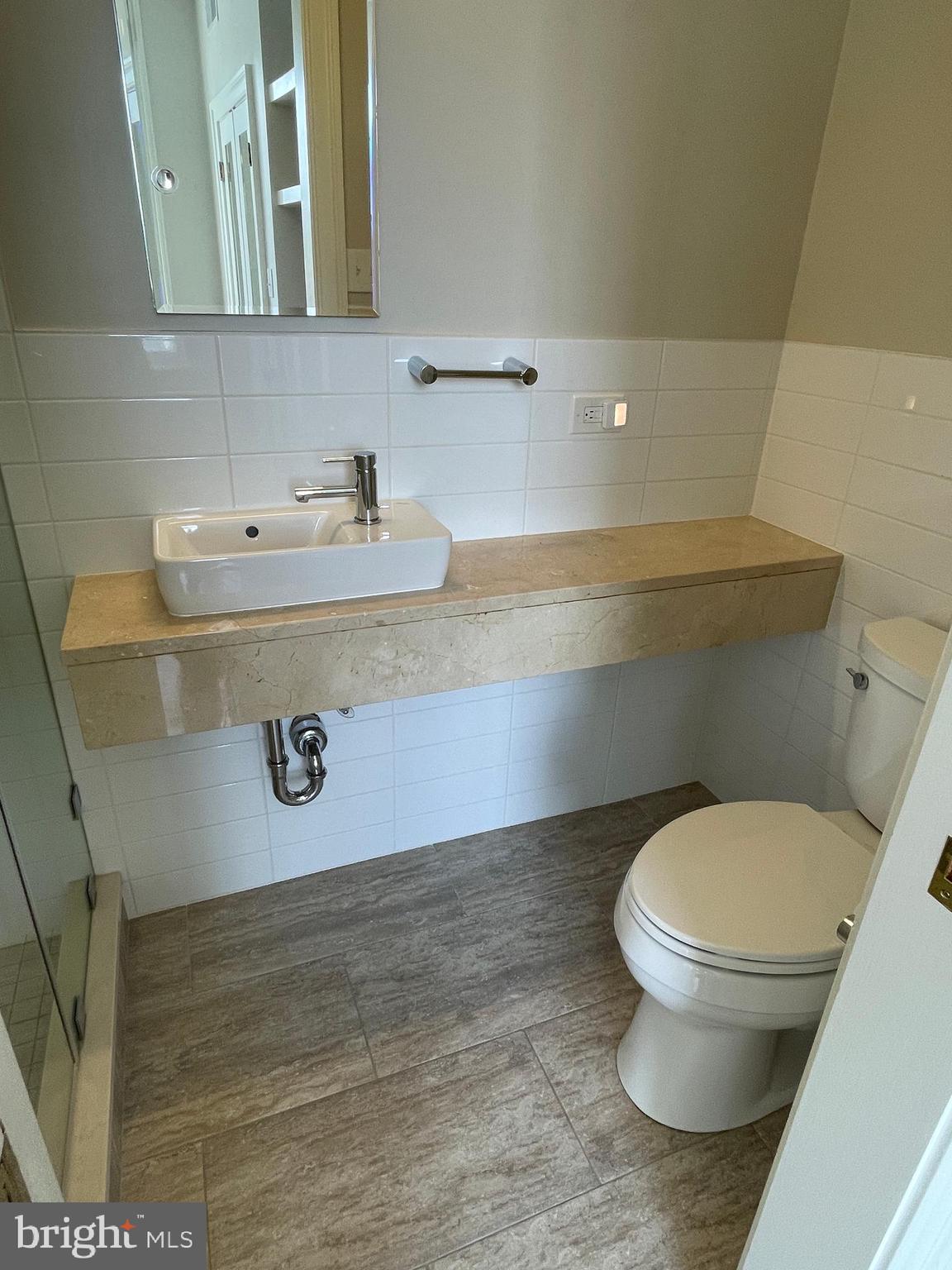 2802 P Street Northwest Washington, DC 20007 - Photo 28 of 58 a bathroom with a sink and a mirror