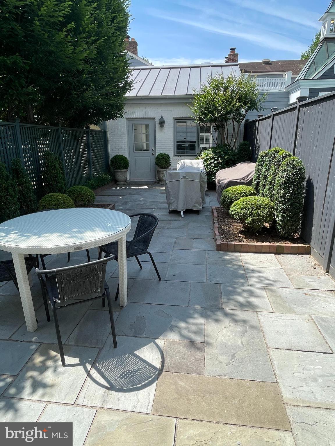 2802 P Street Northwest Washington, DC 20007 - Photo 43 of 58 a view of a patio with table and chairs potted plants with wooden floor