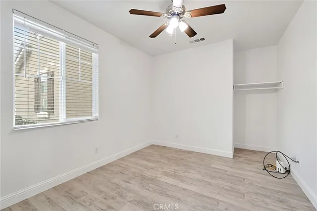 a view of room with window and wooden floor