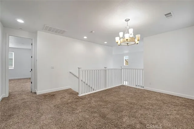 wooden floor with chandelier and window in a room