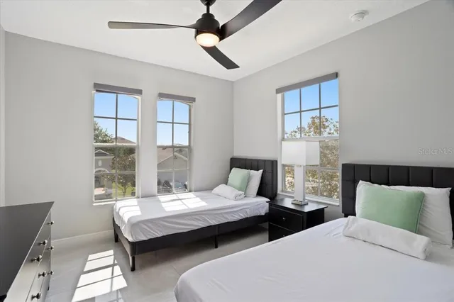 a bedroom with two beds and a window