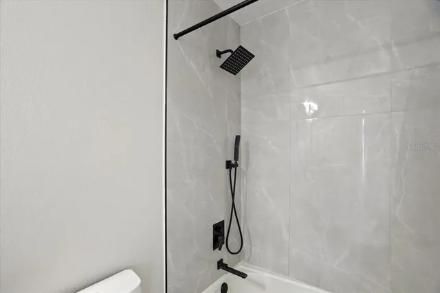 a bedroom with a bed and a ceiling fan