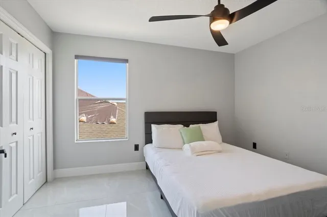 a bedroom with a bed and a window