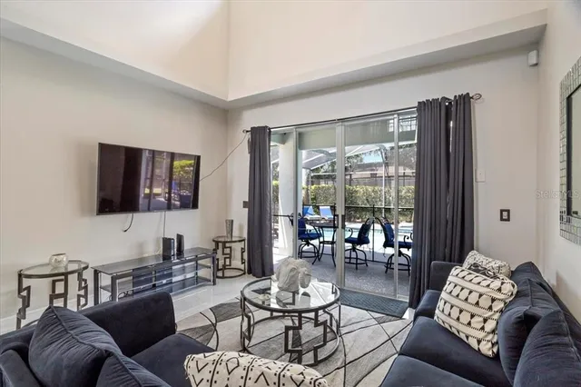 a dining room with stainless steel appliances kitchen island granite countertop a dining table chairs and view living room