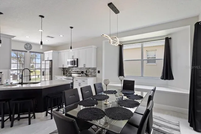 a dining room with furniture and window