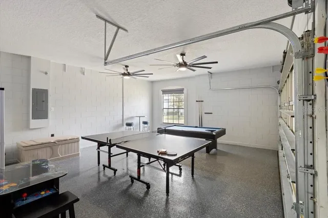 a room with furniture pool table and window