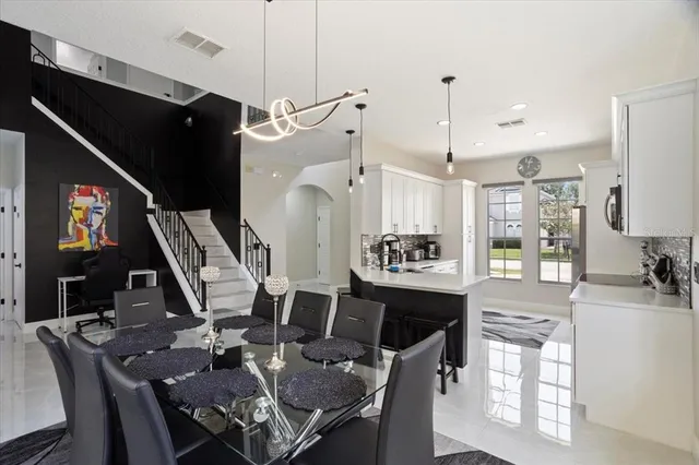 a view of a patio with table and chairs under an umbrella