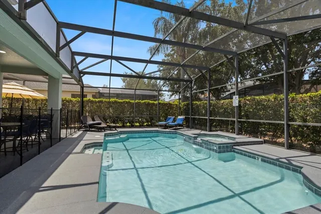 a view of playground with a patio and a yard