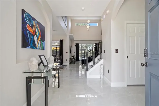 a view of a hallway with wooden floor and furniture