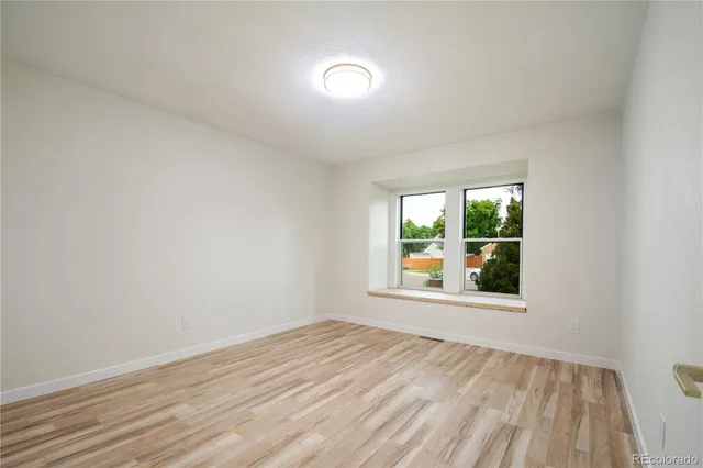 a bathroom with a toilet sink vanity and mirror