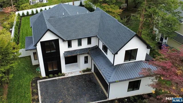 a bath room with a toilet a sink and a mirror