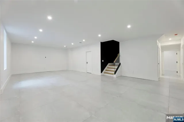 a large kitchen with sink a counter top space and living room view