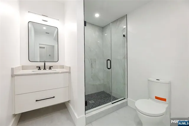 a kitchen with stainless steel appliances granite countertop a stove a sink and a wooden floor