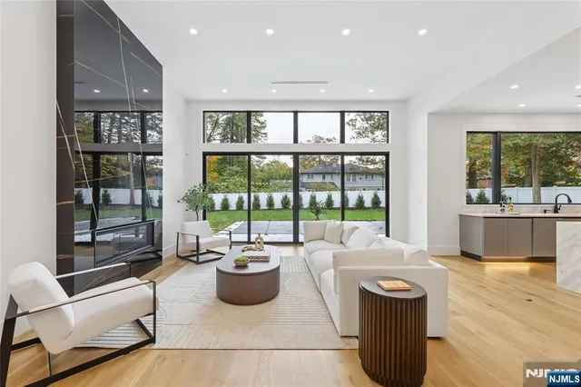 a view of a big room with wooden floor and windows