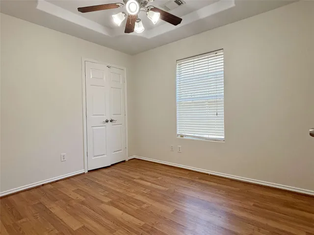 wooden floor in an empty room with a window