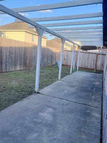 a view of a backyard with wooden fence