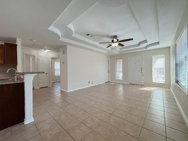 a view of a livingroom with a ceiling fan and window