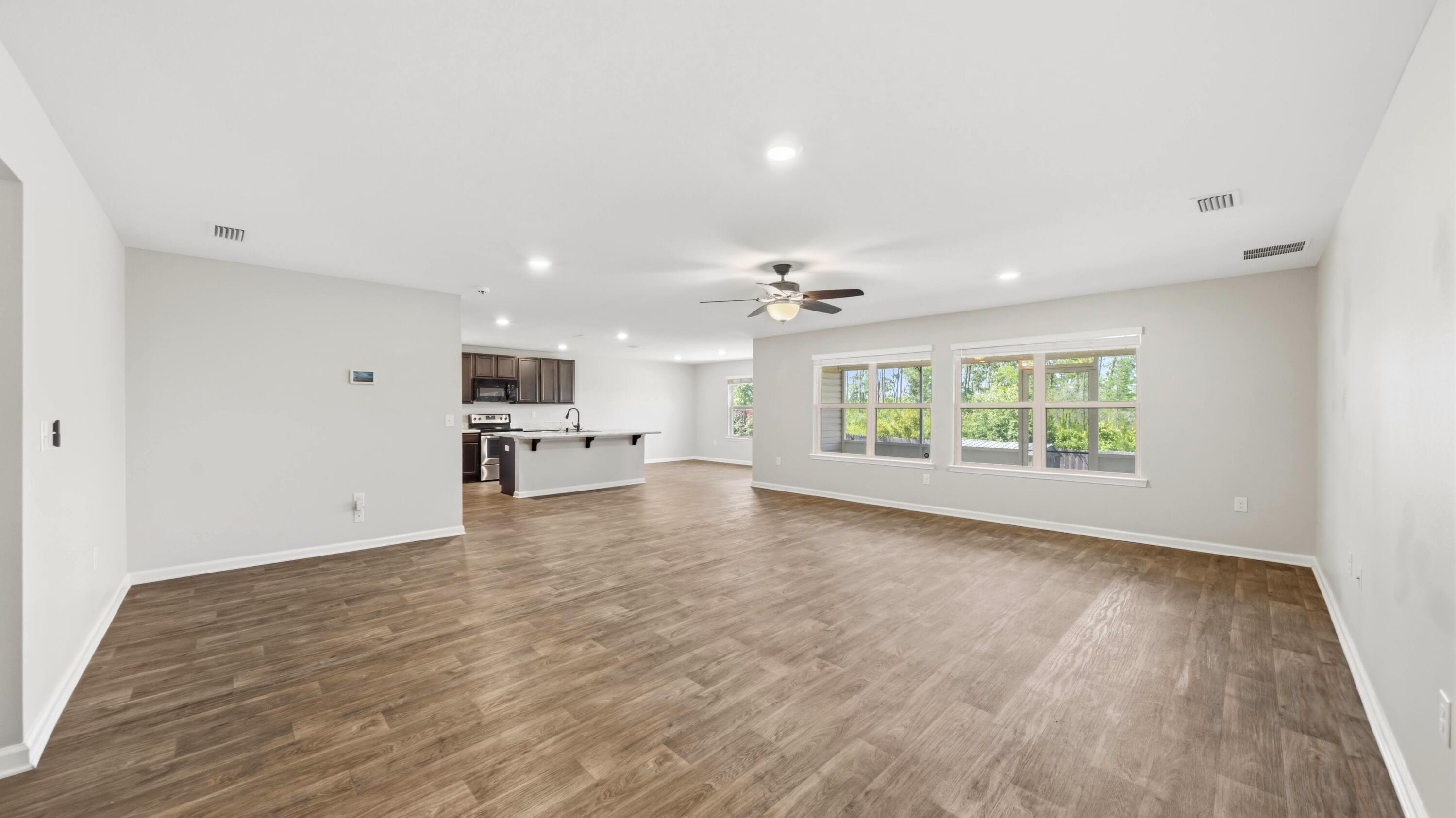 3927 Alva Thomas Road Panama City, FL 32404 - Photo 3 of 46 a view of empty room with wooden floor and window