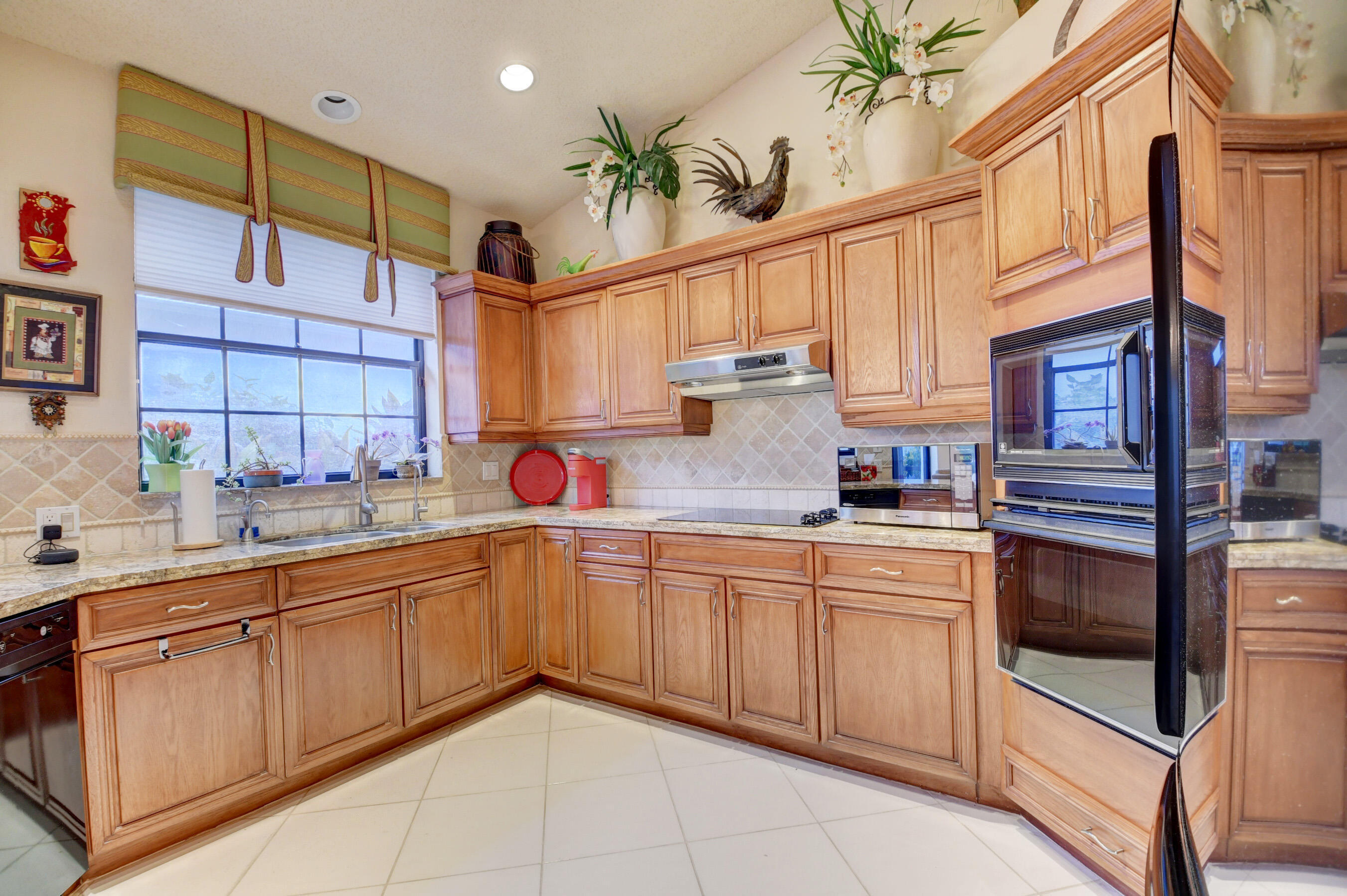 2187 Northwest 59th Street Boca Raton, FL 33496 - Photo 12 of 45 a kitchen with cabinets and window